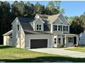 Charming two-story home with a two-car garage and landscaped yard at 437 Earnest Way, Kenly, NC 27542