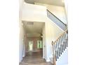 Grand foyer featuring a high ceiling, hardwood flooring, and an elegant staircase with iron spindles at 437 Earnest Way, Kenly, NC 27542