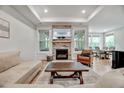 Cozy living room with a stone fireplace, recessed lighting, and lots of natural light at 4408 Walker Hallow St, Raleigh, NC 27616
