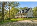 Inviting home with a wraparound porch, perfect for enjoying the natural surroundings and outdoor living at 5019 Dorsey Rd, Oxford, NC 27565
