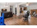 Spacious living room featuring hardwood floors, a fireplace, and open access to the kitchen at 5019 Dorsey Rd, Oxford, NC 27565