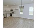 Well-lit kitchen with stainless steel appliances and ample counter space in an open layout at 58 S Grace Way, Henderson, NC 27537