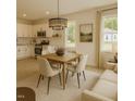 Stylish kitchen and dining area with stainless steel appliances, white cabinets, and hardwood floors at 58 S Grace Way, Henderson, NC 27537