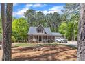View of the home nestled among lush greenery and mature trees, offering privacy at 604 Young Forest Dr, Wake Forest, NC 27587