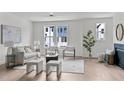 Bright living room with large windows, comfortable seating, and modern décor at 6406 Tanner Oak Ln, Raleigh, NC 27613