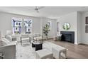Cozy living room with a fireplace, comfortable seating, and large windows for natural light at 6406 Tanner Oak Ln, Raleigh, NC 27613