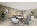Comfortable living room featuring neutral decor, large windows, stylish furniture, and a welcoming atmosphere at 6804 Justice Dr, Raleigh, NC 27615