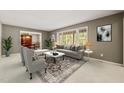 Bright living room featuring large windows, neutral tones, stylish furniture, and an elegant dining area at 6804 Justice Dr, Raleigh, NC 27615