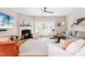Bright living room featuring a cozy fireplace, hardwood floors, and lots of natural light at 705 Samuel Cary Dr, Cary, NC 27511