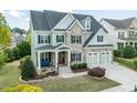 Inviting curb appeal with stone details, an inviting front porch, and a two-car garage at 7101 Gibson Creek Pl, Cary, NC 27519