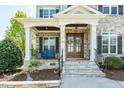 Close-up of the front porch showcasing stone columns and a cozy seating area at 7101 Gibson Creek Pl, Cary, NC 27519