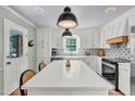 Bright kitchen with white cabinets, a large island, and modern appliances at 905 Tyler Ct, Garner, NC 27529