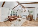 Beautiful living room featuring exposed beams, a fireplace, and ample natural light at 905 Tyler Ct, Garner, NC 27529