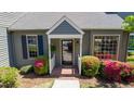 Close-up of the home's entrance, showcasing a well-maintained facade, flowering bushes, and a welcoming front porch at 918 Albany Ct, Raleigh, NC 27615