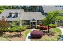 Inviting front of home with landscaped yard, flowering shrubs and manicured lawn at 918 Albany Ct, Raleigh, NC 27615