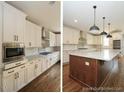 Bright kitchen with white cabinets, stainless steel appliances, granite countertops, and island with wood accent at 97 Fox Oak Trl, Pittsboro, NC 27312
