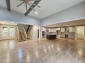 Spacious open-concept living area featuring hardwood floors, wooden beam ceiling, and access to the kitchen and staircase at 97 Fox Oak Trl, Pittsboro, NC 27312