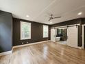 Spacious main bedroom features hardwood floors, neutral color, and a barn door leading to the ensuite bath at 97 Fox Oak Trl, Pittsboro, NC 27312