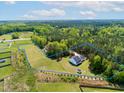 Expansive property featuring a beautifully landscaped lawn and a modern house with a private, wooded perimeter at 9947 Nc Hwy 96 N, Selma, NC 27576
