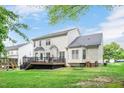 Expansive backyard with lush green lawn, deck and view of the house at 1027 Upchurch Farm Ln, Cary, NC 27519