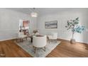 Cozy sitting room with hardwood floors, a modern chandelier, and neutral decor at 103 Ticonderoga Rd, Cary, NC 27519