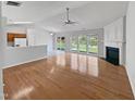 Open living room area with hardwood floors, fireplace, and backyard access at 107 Kinship Ln, Apex, NC 27502