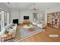 Bright living room featuring vaulted ceiling, fireplace, hardwood floors and neutral decor at 107 Kinship Ln, Apex, NC 27502