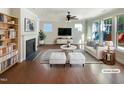 Bright, staged living room with hardwood floors, fireplace, and abundant natural light at 108 Warm Wood Ln, Apex, NC 27539