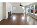 Open concept living room with hardwood floors, a fireplace, and lots of natural light at 108 Warm Wood Ln, Apex, NC 27539