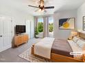 Bright main bedroom features a ceiling fan, stylish décor, and plenty of natural light at 108 Warm Wood Ln, Apex, NC 27539