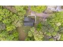 An aerial view of a home surrounded by lush greenery, showcasing its location within a wooded area at 1106 Lake Ridge Dr, Creedmoor, NC 27522