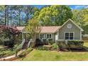 Well-maintained home with manicured landscaping, mature trees, and beautiful green lawn under a blue sky at 1318 Indian Camp Rd, Chapel Hill, NC 27516