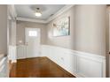 Inviting foyer with hardwood floors, white wainscoting, and a bright white front door at 138 Horizon Trl, Garner, NC 27529