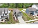 Aerial view of the home, showcasing the surrounding neighborhood and nearby pond at 1501 Addison Lake St, Fuquay Varina, NC 27526