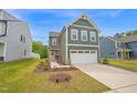 Charming two-story home with a two-car garage and a welcoming pink front door at 1501 Addison Lake St, Fuquay Varina, NC 27526