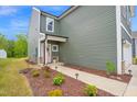 Landscaped front yard with colorful flowers and a walkway leading to the pink front door at 1501 Addison Lake St, Fuquay Varina, NC 27526