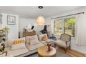 Bright living room featuring hardwood floors, neutral decor, and comfortable seating at 1636 Cone Ave, Apex, NC 27502
