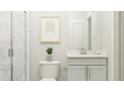 This bathroom features elegant marble tile in shower, and a stylish vanity with modern fixtures at 1645 Goldfinch Perch Ln, Knightdale, NC 27545