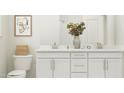 This bathroom features a dual sink vanity, modern fixtures, and ample storage space at 1645 Goldfinch Perch Ln, Knightdale, NC 27545