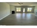 Spacious living room with modern floors, a fireplace, large windows, and backyard access at 1737 Pecan Drive # 21, Nashville, NC 27856