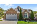 Charming stone home featuring a two-car garage and meticulously manicured landscaping at 2066 Lake Point Dr, Graham, NC 27253