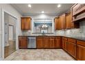 Spacious kitchen with dark wood cabinetry, tile backsplash, and stainless steel appliances at 2066 Lake Point Dr, Graham, NC 27253