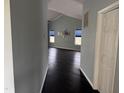 Hallway view into the living room boasting a high ceiling, and dark hardwood flooring at 2124 Claret Ln, Morrisville, NC 27560