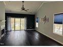 Spacious living room features hardwood floors, fireplace, natural light, and a ceiling fan at 2124 Claret Ln, Morrisville, NC 27560