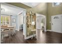 Spacious foyer with hardwood floors and decorative wall art, leading to dining and living areas at 213 Meadow Fox Rd, Holly Springs, NC 27540