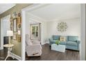 Comfortable living room with hardwood floors, with doorways to dining area, and decorative wall art at 213 Meadow Fox Rd, Holly Springs, NC 27540