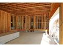 Unfinished room showing wall studs, open ceiling, and concrete floor at 2305 Ballywater Lea Way, Wake Forest, NC 27587