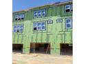 Exterior of a multi-story home shows exposed framing and garage door openings at 3022 White Rail Dr, Fuquay Varina, NC 27526