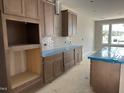 Well-lit kitchen showcasing wood cabinetry, a white tile backsplash, and a spacious island at 3022 White Rail Dr, Fuquay Varina, NC 27526