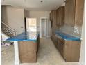 Open-concept kitchen with a spacious island, wood cabinets, and modern finishes awaiting your personal touch at 3022 White Rail Dr, Fuquay Varina, NC 27526